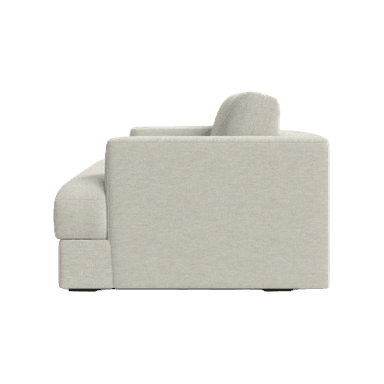 A cream-colored sofa seen from a rear three-quarter perspective. The sofa has a plush, upholstered design with two prominent back cushions. The base is a solid rectangular block, and the armrest on the visible left side is rounded and integrated into the main structure. The fabric appears to have a textured weave. — 3D model