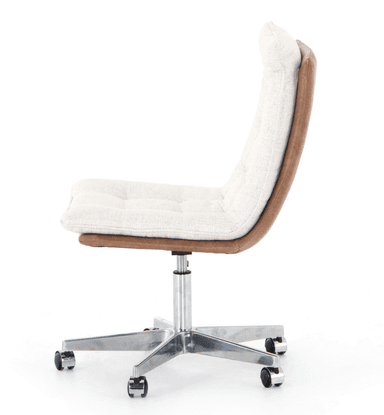 An armless swivel desk chair featuring a tufted upholstered seat and backrest. The upholstery is a light, textured fabric in cream or off-white, with decorative tufting creating a grid pattern. The underside of the seat and the back of the backrest are covered in a contrasting brown material, likely faux leather. The chair sits on a polished metal five-star base equipped with casters for mobility and a gas lift mechanism for height adjustment. — 3D model