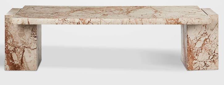 A contemporary bench constructed entirely from solid marble. It features a thick rectangular slab top supported by two robust block-like legs, creating a monolithic and minimalist aesthetic. The marble exhibits natural veining in shades of reddish-brown against a lighter, creamy background. — 3D model