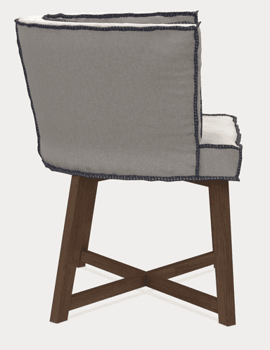 A upholstered armchair viewed from the back. It features a curved backrest with a piped edge in a darker contrasting color. The seat and back are covered in a light gray fabric with visible stitching details along the seams and edges. The chair is supported by four wooden legs, with two front legs and two back legs that are slightly angled, connected by an X-shaped stretcher. — 3D model