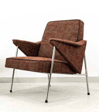 A Mid-Century Modern lounge chair featuring a textured, reddish-brown fabric upholstery with black piping details. The chair is supported by a slender, polished chrome frame that forms the legs and extends to support the wide, upholstered armrests. The seat and backrest are well-padded, providing a comfortable, relaxed posture. The design emphasizes clean lines and a minimalist profile, characteristic of the mid-20th century aesthetic. — 3D model