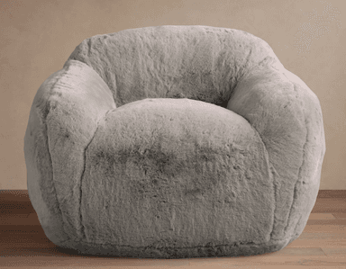 A plush, light gray faux fur lounge chair with a rounded and inviting silhouette. The chair features integrated, soft armrests and a contoured back, entirely covered in a shaggy, soft material. It appears to be a soft-filled design, resting directly on the floor without visible legs. — 3D model