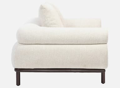 A side view of a contemporary sofa featuring thick, rounded, cream-colored boucle upholstery and a minimalist dark wood base with cylindrical legs. — 3D model