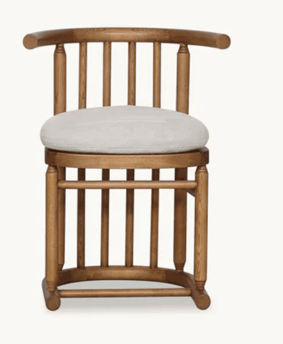 A robust wooden armchair featuring a distinctive tub or barrel back design composed of multiple vertical spindles. It has a curved top rail that forms both the backrest and armrests, supported by turned posts. The chair includes a circular, light-colored upholstered cushion for the seat, complementing the medium-toned natural wood frame. The base mirrors the spindle design, offering a sturdy and cohesive aesthetic. — 3D model