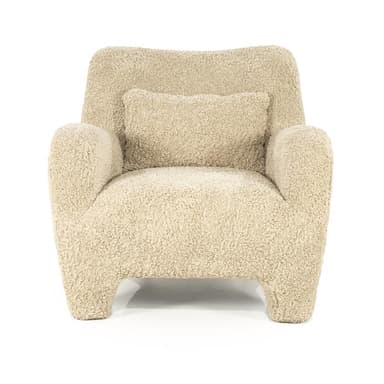 A cream-colored armchair with a rounded silhouette, upholstered in a textured fabric resembling boucle or sherpa. It features broad, enveloping arms, a high back, and four short, chunky legs. A small, square throw pillow with matching upholstery is placed on the seat against the back. — 3D model