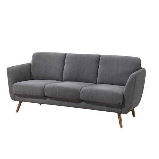 A three-seater sofa with a low profile and gently curved arms. It features a padded backrest and seat cushions, upholstered in a soft, grey fabric. The sofa is supported by four tapered wooden legs, angled outwards. — 3D model