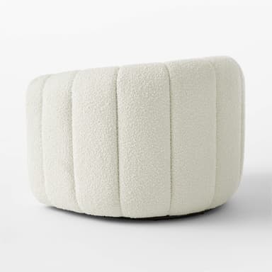 A cream-colored, rounded ottoman with vertical channel tufting across its exterior. The upholstery has a textured, boucle-like finish. The base appears to be dark and low-profile, supporting the cylindrical body of the ottoman. — 3D model