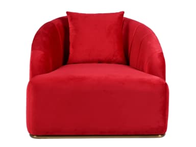 A vibrant red velvet armchair featuring a rounded, club-chair silhouette with a deeply cushioned seat and back. The exterior backrest is detailed with vertical channel tufting, creating a fluted effect. The chair rests on a low, recessed plinth base finished in a metallic brass tone. A matching square throw pillow is included. — 3D model