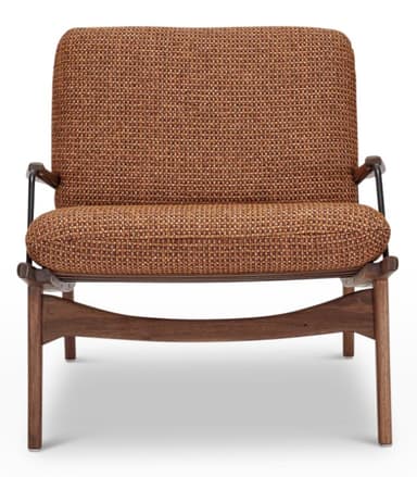 A mid-century modern armchair featuring a wooden frame, upholstered seat and backrest, and leather straps. The armchair has a distinctive silhouette with angled legs and armrests. The backrest is supported by a woven leather panel and held in place by adjustable leather straps with brass buckles. The seat and back cushions are upholstered in a textured, woven fabric. — 3D model