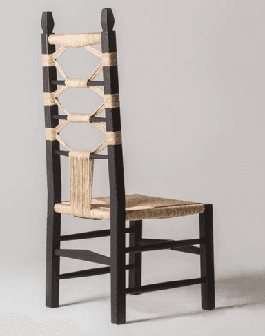 A dark-stained wooden chair with a high back, featuring a seat and backrest woven from natural fiber material. The backrest is characterized by a decorative interlacing of rope or twine, creating an open, geometric pattern. The chair has four legs connected by stretchers for stability, and the rope detailing extends to the stretchers. — 3D model