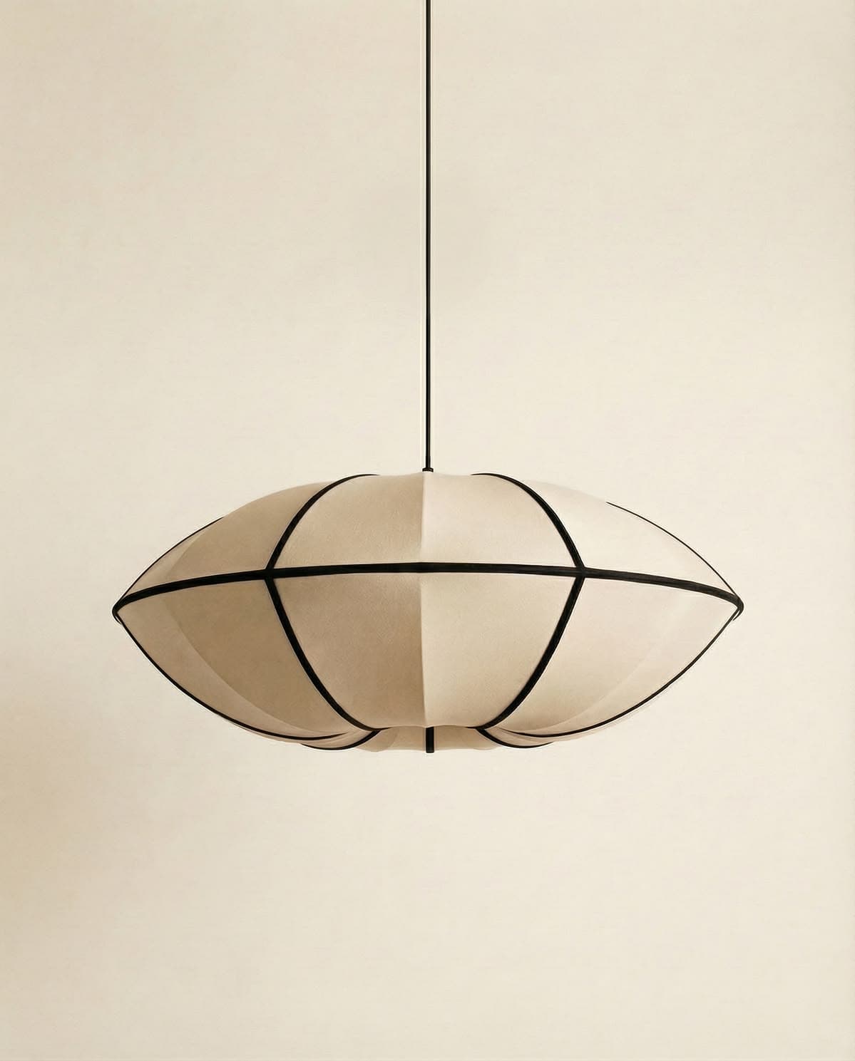 A pendant light fixture featuring an oval-shaped shade constructed from fabric panels stretched over a frame. The shade is segmented by dark, thin framing elements that create a geometric pattern. The light is suspended from a thin cable or rod. — 3D model