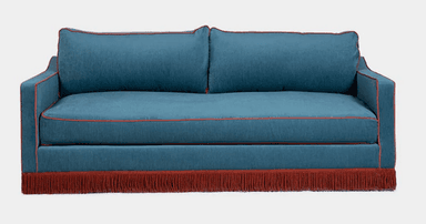 A contemporary sofa upholstered in a vibrant teal blue fabric, featuring square arms and a tight back. The base is adorned with a deep red fringe skirt, and all edges of the cushions, arms, and backrest are highlighted with contrasting red piping. — 3D model
