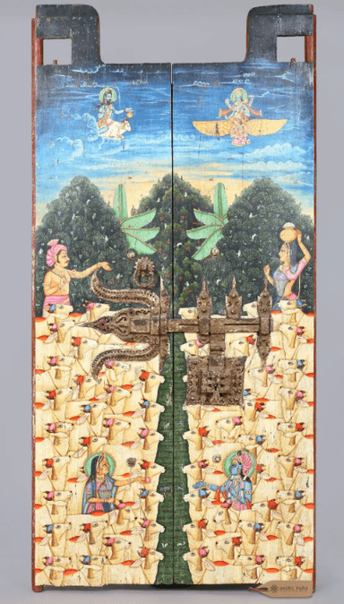 A pair of antique Indian wooden door panels, hinged together and secured by an ornate iron latch. The panels are extensively hand-painted with vibrant, multi-scene artwork depicting Hindu deities and numerous stylized cattle, set against a landscape and sky background. The central iron latch is intricate and appears aged, complementing the distressed finish of the wooden panels. The top edges feature carved, projecting elements. — 3D model