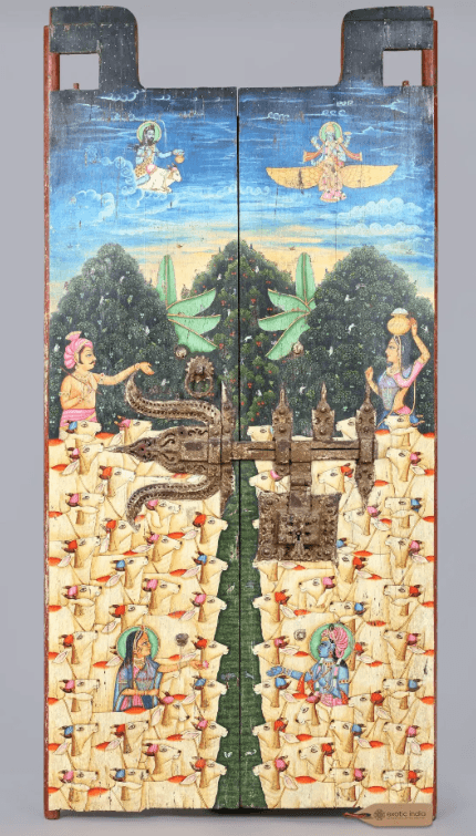 A pair of antique Indian wooden door panels, hinged together and secured by an ornate iron latch. The panels are extensively hand-painted with vibrant, multi-scene artwork depicting Hindu deities and numerous stylized cattle, set against a landscape and sky background. The central iron latch is intricate and appears aged, complementing the distressed finish of the wooden panels. The top edges feature carved, projecting elements. — 3D model