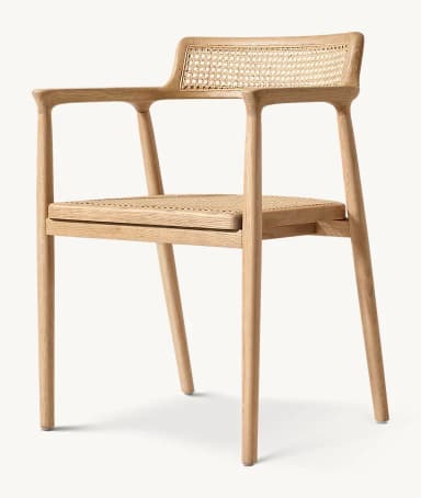 A modern dining armchair crafted from light-colored solid oak wood with natural cane weaving on both the backrest and the seat. The chair features a minimalist frame with rounded edges, integrated armrests that flow from the backrest, and four straight, tapered legs. — 3D model