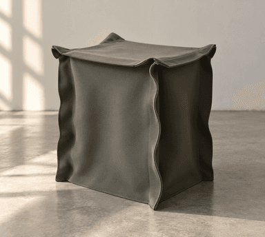 A precisely rendered cube-shaped ottoman, upholstered in a uniform dark olive green fabric, featuring distinct stitched seams along its edges. — 3D model