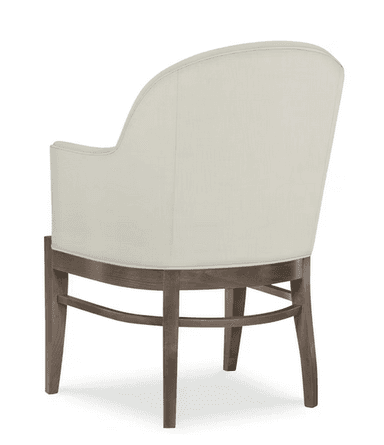A cream-colored armchair with a high, curved back and upholstered arms. The seat is also upholstered in the same fabric. The frame and legs are made of wood with a weathered, gray-brown finish. The legs have a slightly tapered profile. — 3D model