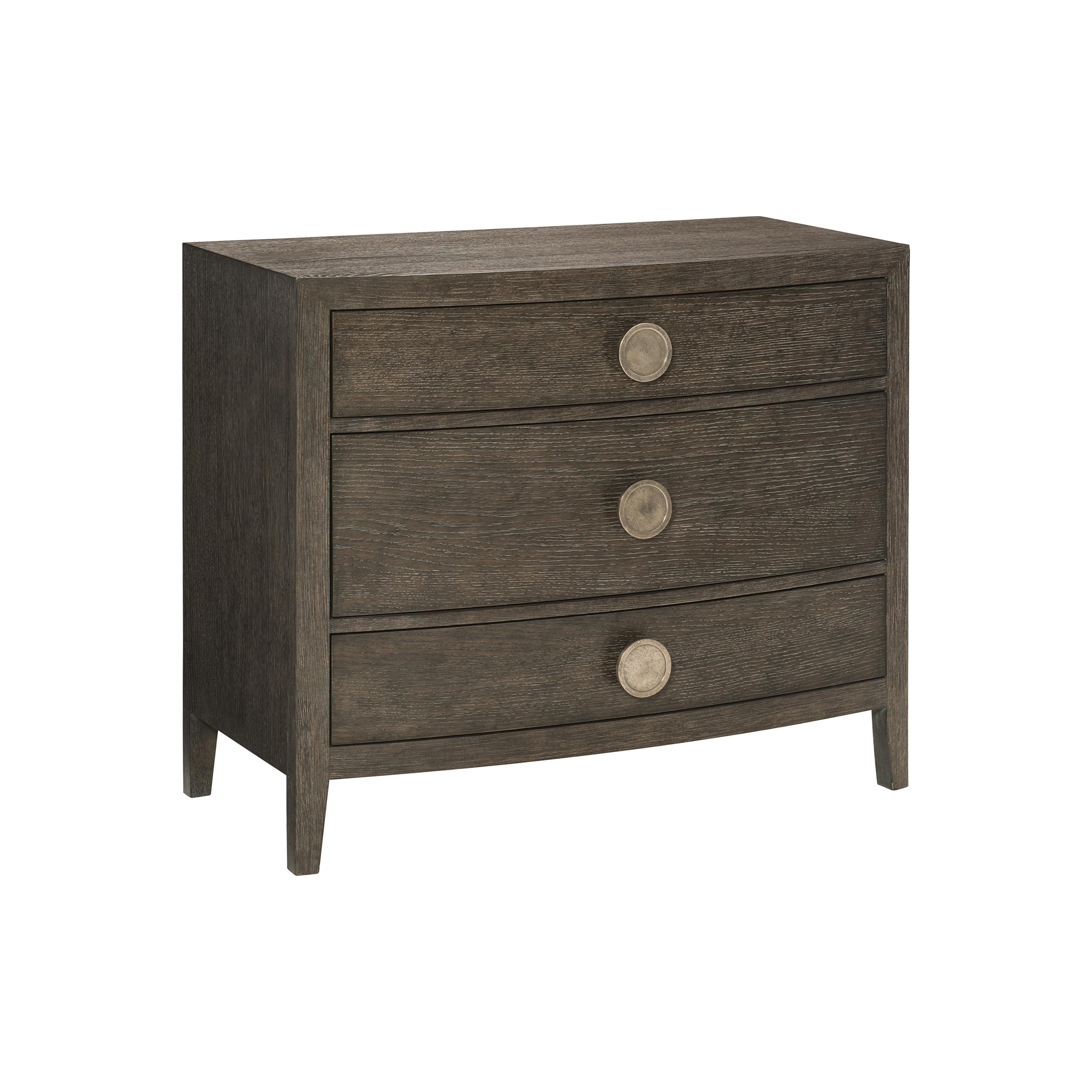 A three-drawer nightstand with a dark wood finish and curved drawer fronts. Each drawer is adorned with a single, circular, metallic knob. The nightstand stands on four tapered legs. — 3D model