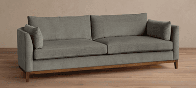 A contemporary two-seater sofa featuring gray fabric upholstery, loose seat and back cushions, and a visible wooden frame base with tapered legs. — 3D model