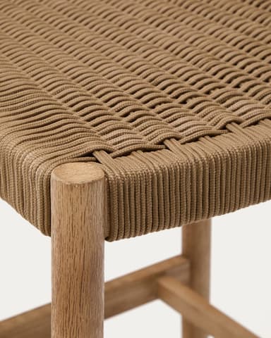 A light-toned solid wood bar stool with a woven rope seat and a curved, low backrest. It features a sturdy four-legged frame with a metal footrest bar for comfort and support. The design is minimalist and draws from natural materials. — 3D model