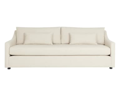 A contemporary sofa with a light-colored textured fabric upholstery. It features a deep seat, loose back cushions, and two accent pillows. The arms are gently sloped, and the sofa rests on short, dark-colored legs. — 3D model