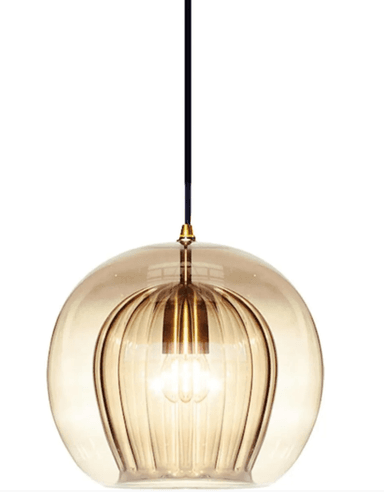 A modern pendant light featuring a large, spherical, frosted glass shade suspended by a black electrical cord and a brass-finished cap. The internal light source creates a warm, diffused glow within the globe. — 3D model