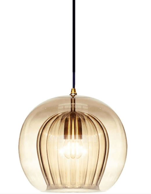 A modern pendant light featuring a large, spherical, frosted glass shade suspended by a black electrical cord and a brass-finished cap. The internal light source creates a warm, diffused glow within the globe. — 3D model