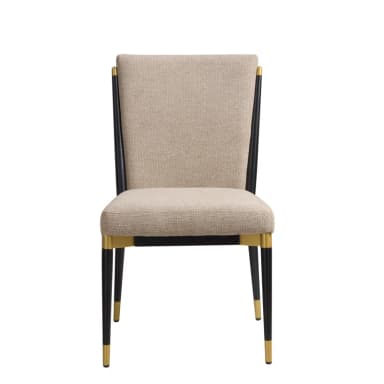 An armless dining chair featuring a slim profile with an upholstered seat and back. The frame is constructed from black metal tubing, with brass-finished accents at the top of the backrest connection and as caps on the bottom of each leg. The upholstery is a light beige or cream-colored textured fabric. — 3D model
