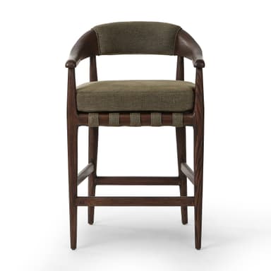 A bar stool with a wooden frame and upholstered seat and backrest. The frame is constructed from dark wood with visible grain. The seat and backrest are upholstered in a textured, olive-green fabric. The stool has a curved backrest that extends to armrests, and its legs are supported by crossbars. — 3D model