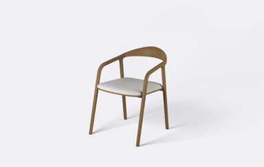 A modern armchair featuring a curved wooden frame that seamlessly integrates the armrests and backrest, complemented by a light gray upholstered seat pad. — 3D model