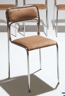 A modern armless chair featuring a polished tubular steel frame and upholstered seat and backrest in a light tan color. The frame forms a continuous loop for the back support and rear legs, with separate front legs. The design is clean and utilitarian. — 3D model