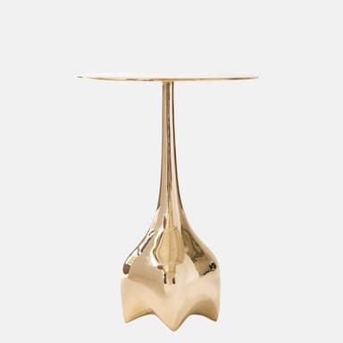 A striking gold-finished metal table featuring a circular top, a slender, tapered stem, and a distinctive sculptural base with a fluted, organic form. The entire piece has a lustrous, hammered-like texture, suggesting artisanal craftsmanship and a luxurious aesthetic. — 3D model