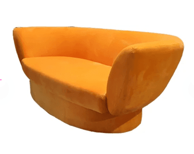 A modern, low-profile sofa with a rounded, sculptural form. The sofa features a single bench-style seat cushion and a curved, enveloping backrest. It is upholstered in a soft, textured fabric and sits on a solid, circular base. The design emphasizes smooth lines and a cohesive silhouette. — 3D model
