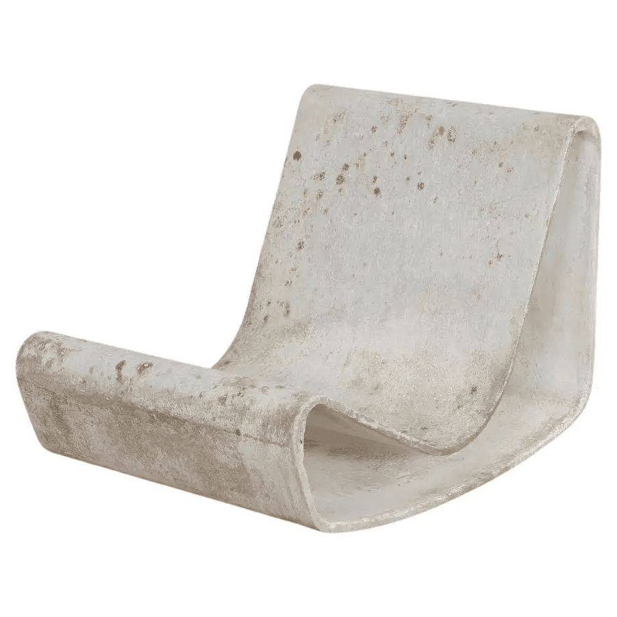 A sculptural lounge chair, likely made from a single piece of molded fiberglass or a similar composite material. It features a continuous, curved form that provides both the seat and backrest. The material is light-colored, possibly off-white, and shows significant signs of wear, discoloration, and potential staining, suggesting age or prolonged outdoor exposure. The design is minimalist and organic. — 3D model
