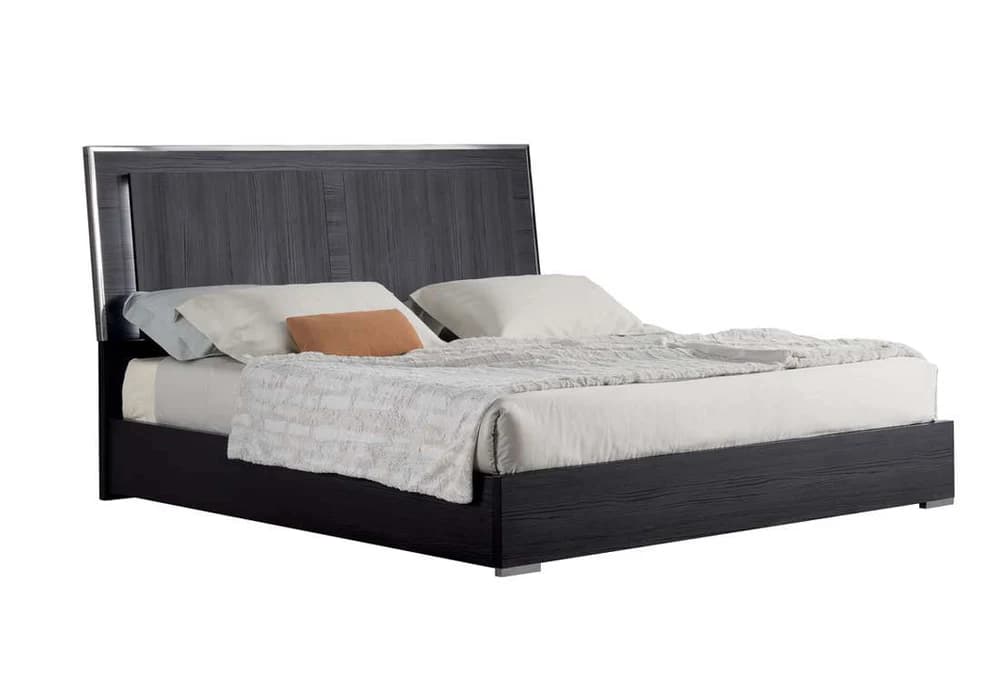 A modern platform bed frame with a dark wood grain finish on the headboard and frame. The headboard is rectangular with vertical wood paneling and has a sleek, metallic trim along the top and sides. The bed is shown with white bedding, including pillows and a textured throw blanket. The base of the bed is a low-profile platform. — 3D model