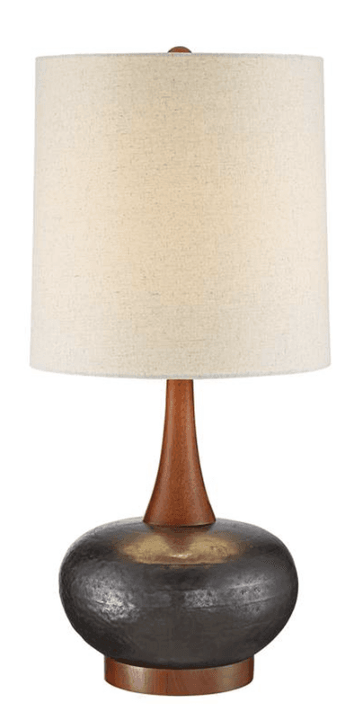 A modern table lamp featuring a hammered dark metal spherical base, a tapered natural wood stem, and a cylindrical cream fabric lampshade, set on a round wooden foot. — 3D model