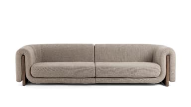 A modern two-seater sofa featuring a clean, curved silhouette. It is upholstered in a textured beige or light brown fabric. Distinctive dark wood panels are integrated into the lower outer sides of the armrests, extending to form part of the base. The armrests themselves are generously padded and rounded. The sofa has two plush seat cushions and a continuous backrest. — 3D model