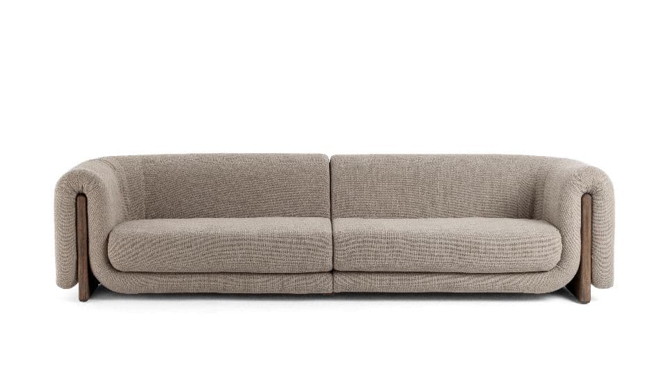 A modern two-seater sofa featuring a clean, curved silhouette. It is upholstered in a textured beige or light brown fabric. Distinctive dark wood panels are integrated into the lower outer sides of the armrests, extending to form part of the base. The armrests themselves are generously padded and rounded. The sofa has two plush seat cushions and a continuous backrest. — 3D model