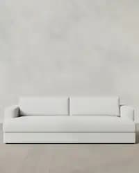 A modern, light-colored sofa featuring a clean, minimalist design with boxy track arms and plush, integrated cushions. — 3D model