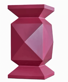 A modern and sculptural pedestal table featuring a unique faceted geometric design, finished in a vibrant matte magenta color. Its form tapers inwards from the top and bottom, creating an hourglass-like silhouette with sharp, angular planes. — 3D model