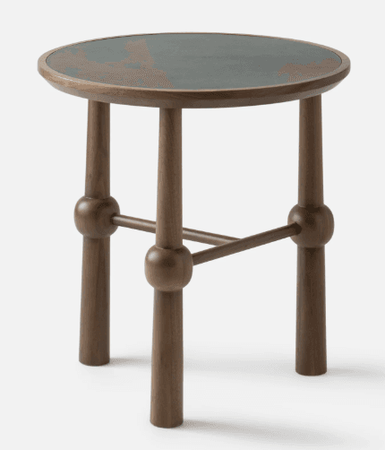 A small, contemporary accent table crafted from dark-toned walnut wood, featuring a circular tabletop with a dark green or charcoal-colored inlay. The table stands on three robust, tapered legs, which are visually segmented by distinct spherical details where connecting stretchers converge. This design creates a sculptural and modern aesthetic. — 3D model