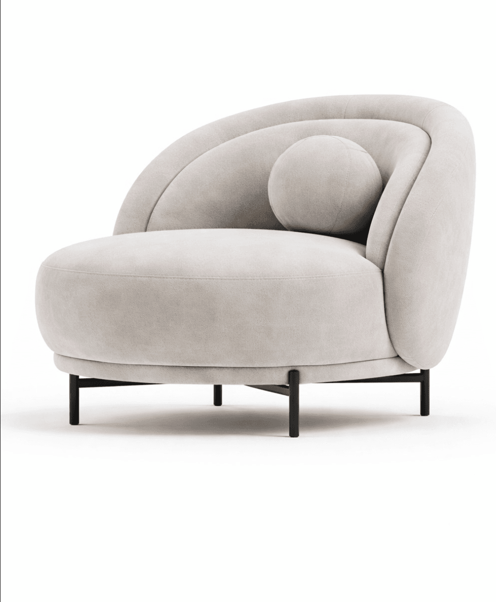 A contemporary armchair with a rounded, organic silhouette. The chair features a deep, plush seat, a curved backrest that sweeps upwards and around, and a detached spherical accent pillow. It is supported by a minimalist, dark metal base with four slender legs. — 3D model