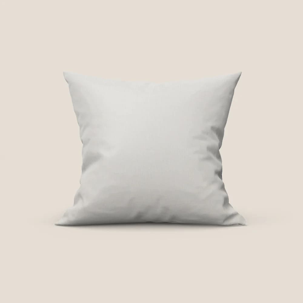 A square pillow with a slightly textured white fabric cover. The pillow appears plump and is shown against a plain, light beige background. The lighting casts subtle shadows, highlighting the pillow's soft form. — 3D model