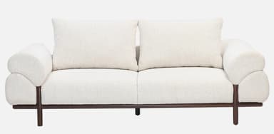 A side view of a contemporary sofa featuring thick, rounded, cream-colored boucle upholstery and a minimalist dark wood base with cylindrical legs. — 3D model