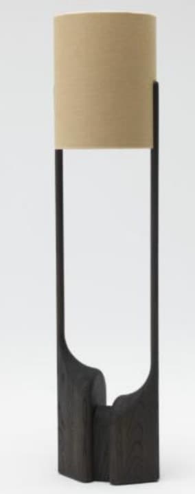 A tall, contemporary floor lamp featuring a sculptural dark-stained wooden base with an organic, carved form, supporting a slender dark-toned vertical stem that holds a cylindrical beige fabric lampshade. — 3D model