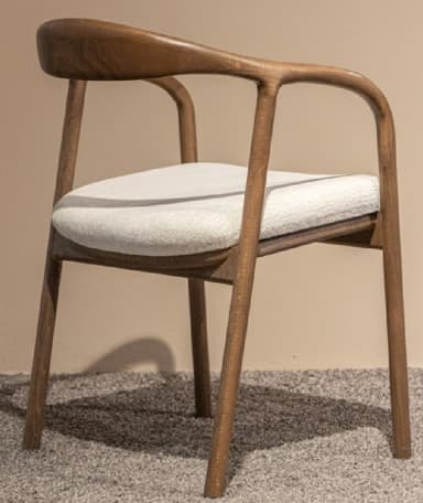A modern dark wood armchair featuring a continuous curved backrest and armrests, supported by a sturdy four-legged frame. The chair is fitted with a light-colored, cream or off-white, upholstered seat cushion. — 3D model