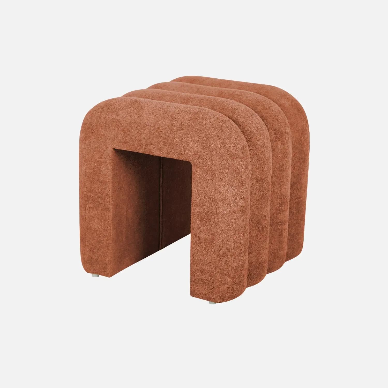 A modern, upholstered ottoman with a distinctive fluted design. The piece features a series of curved vertical elements that create a cohesive, sculptural form. It has a rectangular opening at the bottom and appears to be supported by small, discreet feet. — 3D model