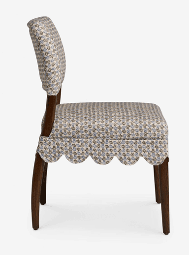 A traditional upholstered side chair featuring a scalloped fabric skirt and a small floral pattern. It has a fully upholstered seat and back, supported by dark wooden tapered legs. — 3D model