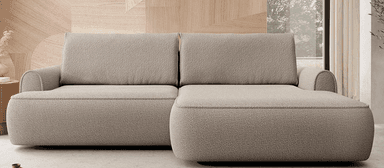 A sectional sofa with a chaise lounge. The sofa features a textured boucle fabric upholstery in a neutral beige tone. It has a low-profile design with padded armrests and back cushions. The construction appears to be modular, with distinct seating sections and a chaise extension. — 3D model