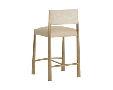 A contemporary bar stool with a metal frame and upholstered seat and backrest. The frame has a warm metallic finish and features tapered legs connected by a footrest. The seat and backrest are padded and covered in a neutral-toned fabric. — 3D model